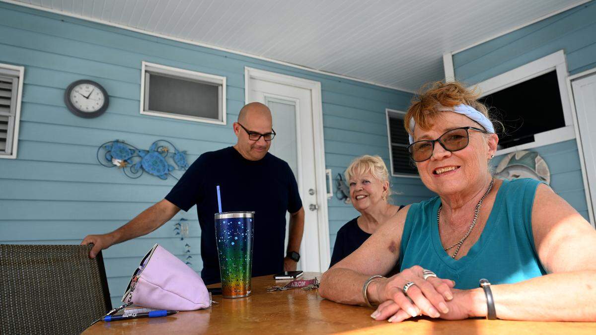 George Savinon, Donna and Denise Pura smile after prepping their homes in Trailer Estates to evacuate to a nearby hotel as Hurricane Helene approaches Manatee County on Wednesday, Sept. 25, 2024.