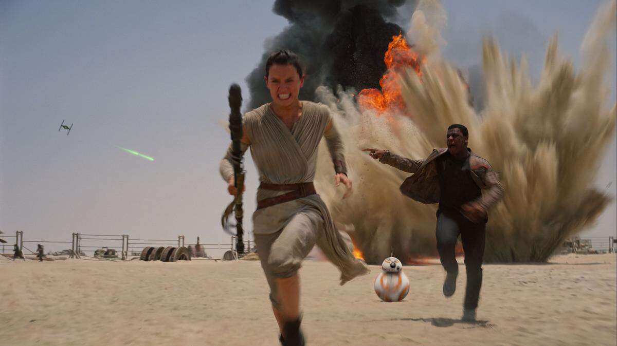 Daisey Ridley as Rey and John Boyega as Finn in a scene from "Star Wars: Episode VII -- The Force Awakens," directed by J.J. Abrams. The movie releases in the United States on Dec. 18, and it is already setting records for pre-opening ticket sales. PUBLICITY PHOTO