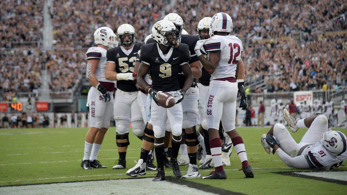University of Central Florida running back Adrian Killins Jr. (9) is congratulated after rushing for a touchdown during the first half of an NCAA college football game against South Carolina State on Sept. 8. in Orlando.