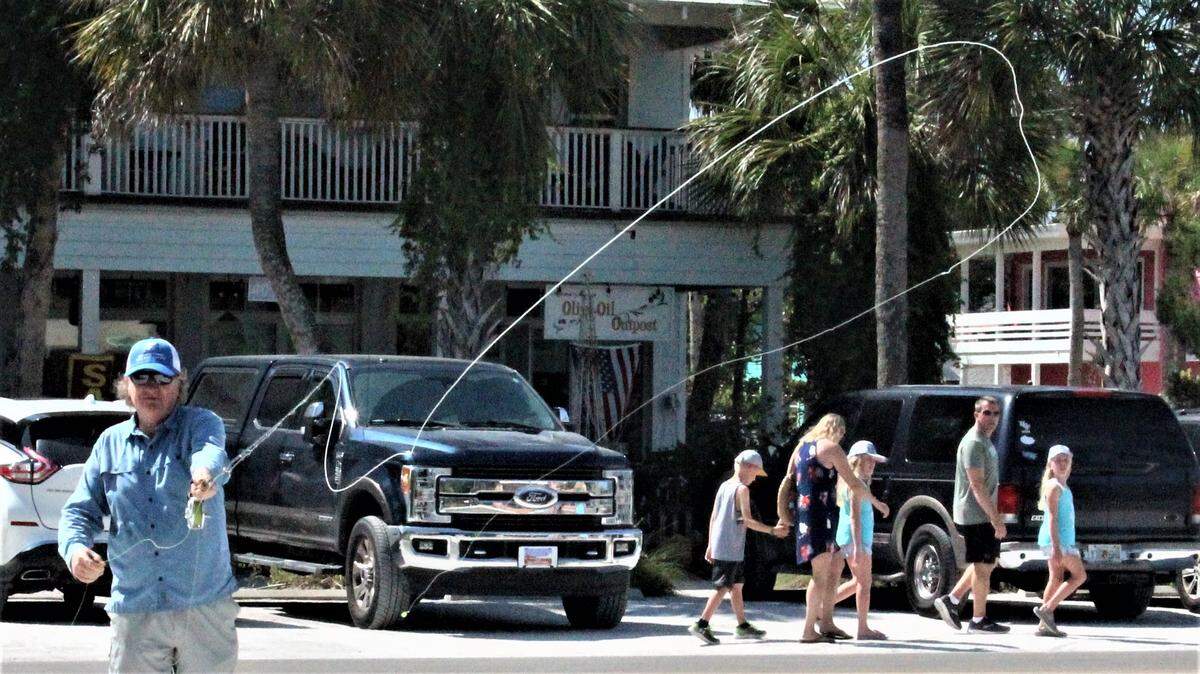 Steve Traves demonstrates his fly fishing casting technique in a parking lot across from AMI Outfitters Coastal Gear and Apparel, 401 Pine Ave., Anna Maria.