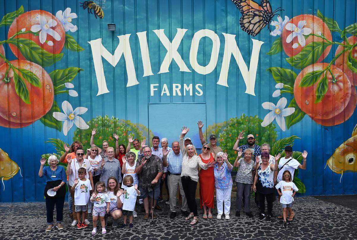 Employees of Mixon Fruit Farm’s sandwich and ice cream shop gather to wave goodbye in advance of closing the store on July 29, 2023.