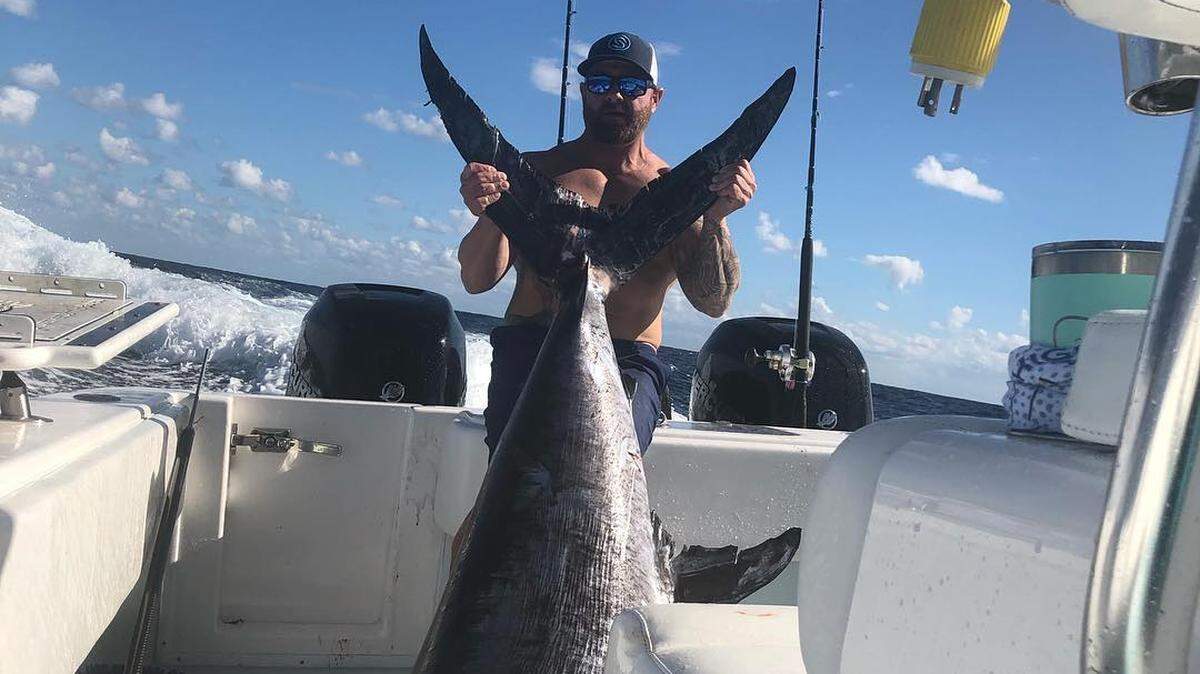 Kyle Shea with a swordfish caught recently that weighed an estimated 350 pounds.