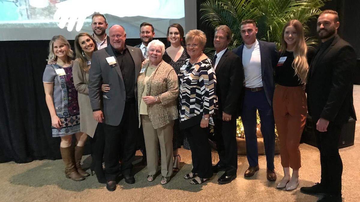 Ron Allen, fourth from left, recipient of the Robert P. Bartz Award for Outstanding Leadership, poses with his family for a photograph Thursday at the Bradenton Area Convention Center.