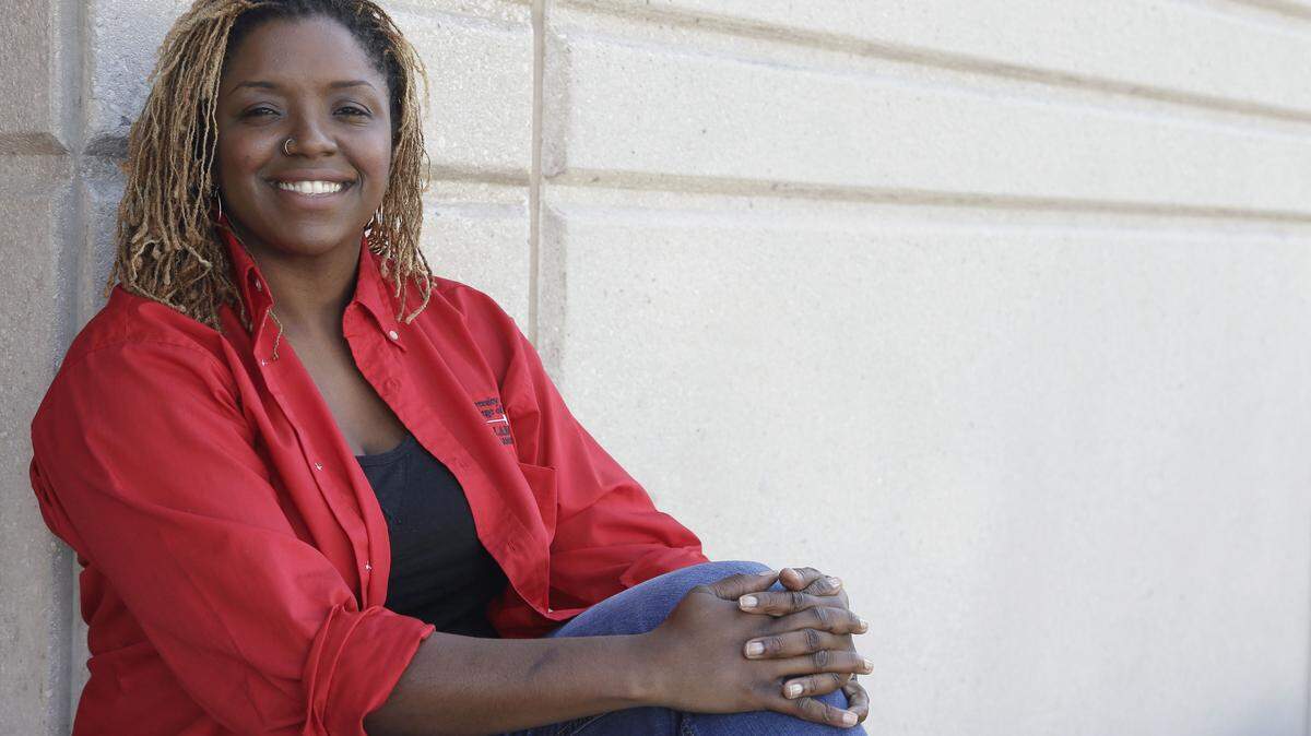 Roni Dean-Burren poses on the campus of the University oh Houston Monday, Oct. 5, 2015, in Houston. Dean-Burren is asking publisher McGraw-Hill Education to change the text in a geography book that refers to slaves as workers from Africa. (AP Photo/Pat Sullivan)