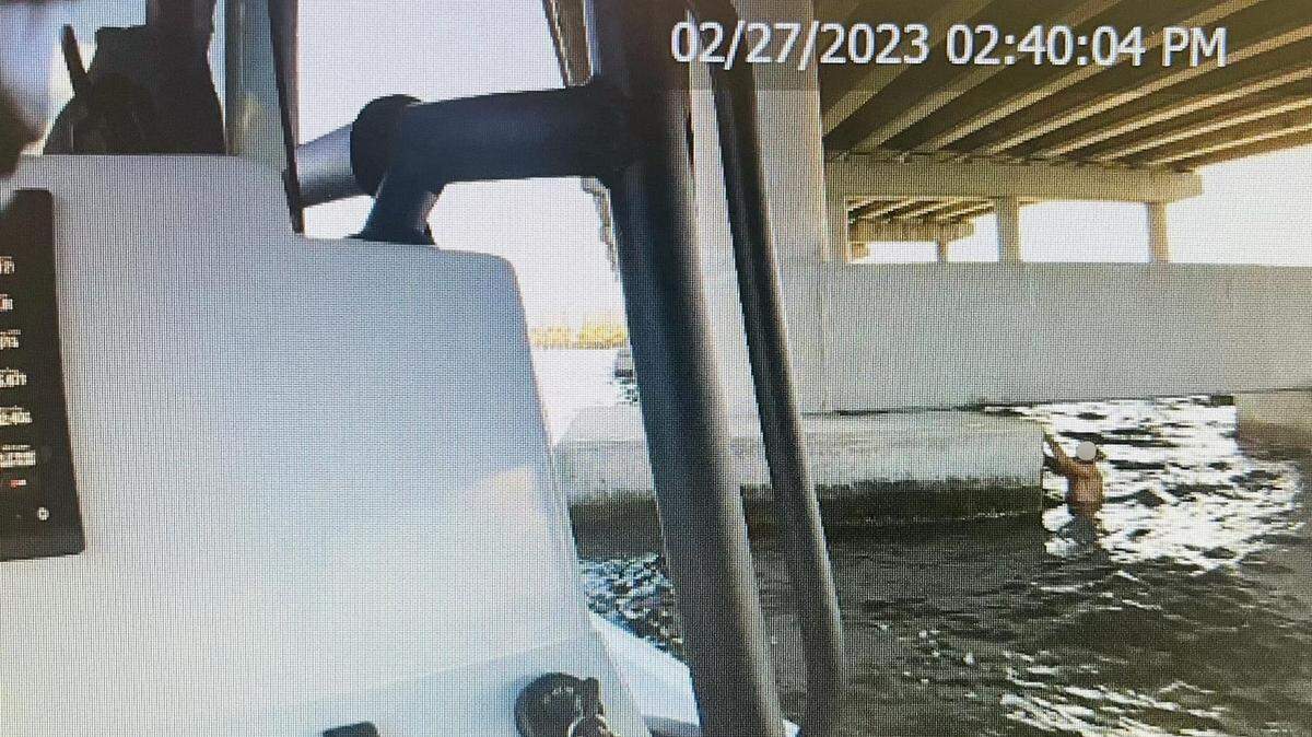 A man was found by Palmetto Police underneath the Green Bridge. In this photo from an officer’s body cam, the man can be seen holding on to the bridge on Feb. 27, 2023.