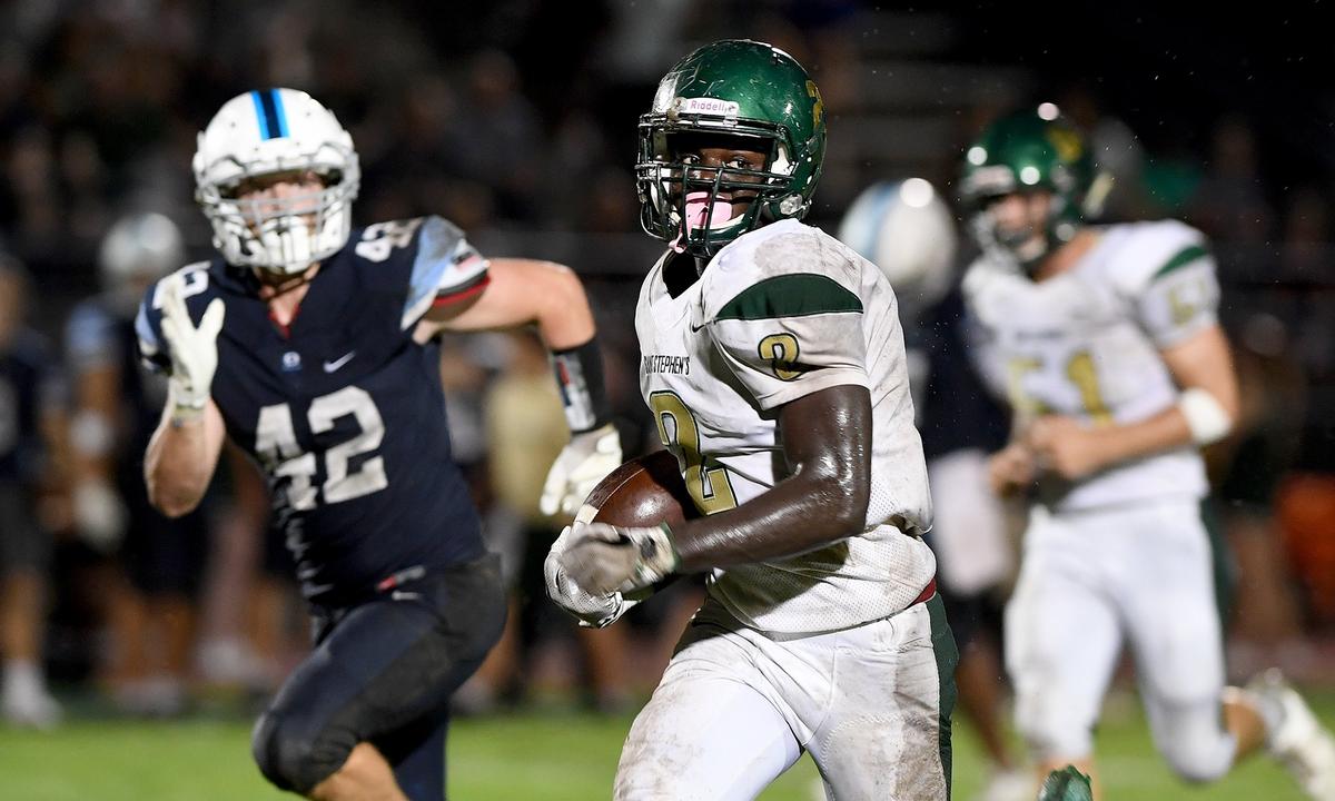 St. Stephen’s Daniel Clark runs the ball during Friday night’s game at Out of Door Academy.