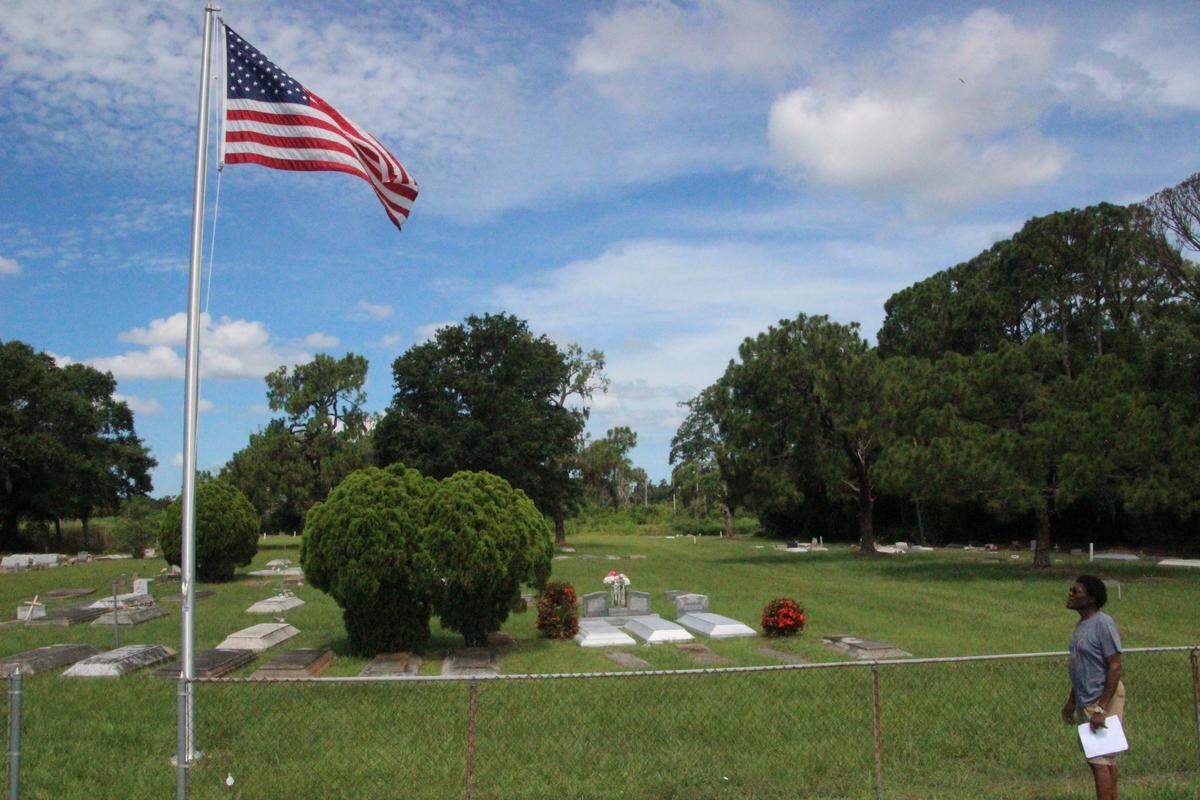 An American flag now flutters over the Rubonia Cemetery. Charles Miller Sr, right, rallied community support for the flag, and got it installed in time for the Fourth of July holiday.
