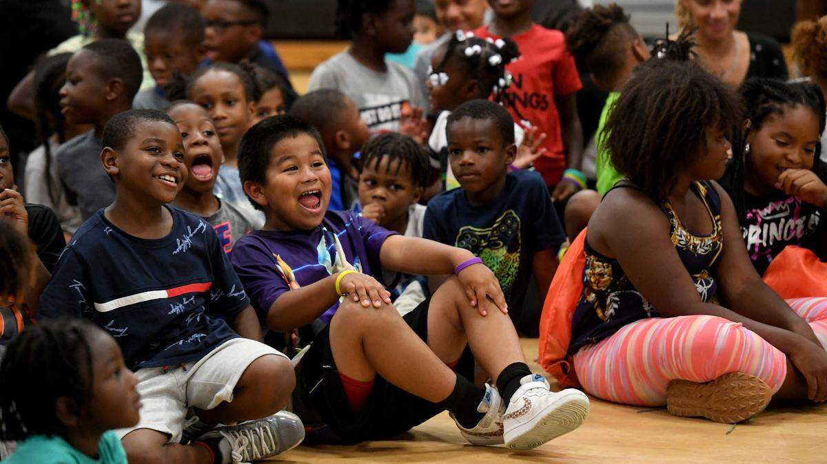 Children respond to author Vincent Taylor Friday at the 13th Av Center during a presentation encouraging audience participation. The Rosalyn Walton Education and Enrichment Services, Inc along with the 13th Avenue Dream Center is hosting the 6th Annual Juneteenth Reading Conference and Community Festival which continues Saturday.