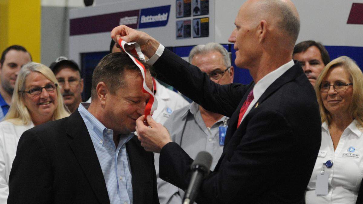 Jim Westman, owner and CEO of Octex, is presented with the Governor's Business Ambassador award by Florida Gov. Rick Scott in January 2016 during a visit to Octex in Sarasota. 
 GRANT JEFFERIES/Bradenton Herald