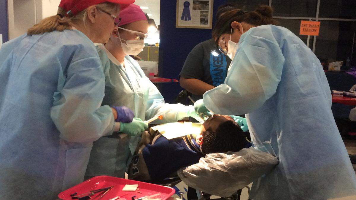 Volunteers perform dental work on one of the more than 1,600 patients in the Bradenton area who were provided nearly $1 million in health care, dental and vision services at the Remote Area Medical USA clinic that was held at Manatee Technical College in November. 
 JESSICA DE LEON/Bradenton Herald file