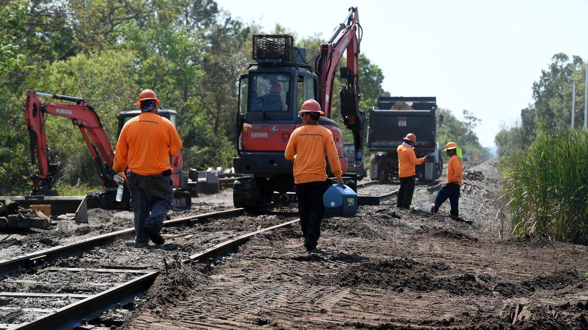 Workers repair the tracks where a Seminole Gulf Railway derailment occurred on Feb. 28th in Manatee County where one of the cars carrying 30,000 gallons of propane came off the tracks and was on its side.