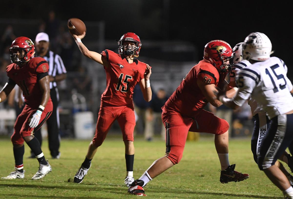 Connor O’Sullivan throws for a pass ending in a touchdown during Friday night’s football game between Cardinal Mooney and Calvary Christian at Cardinal Mooney.