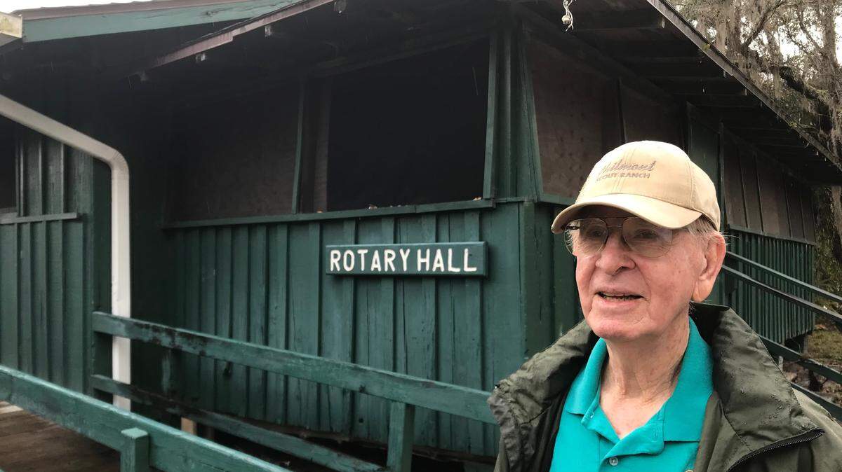 B.J. “Red Dog” Maynard stands next to Rotary Hall, which was constructed in 1929 and is the oldest building at Camp Flying Eagle.