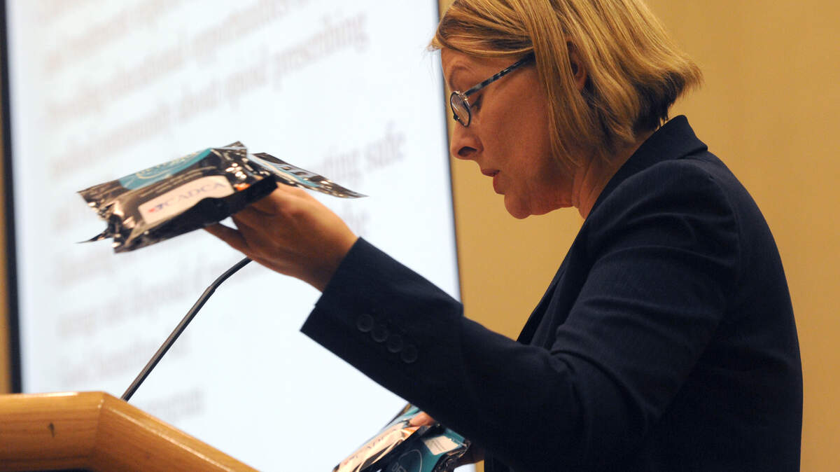 Jessica Spencer, with the Manatee County Substance Abuse Prevention Coalition, hands out a sample of Deterra, a product use to dispose of unwanted prescription drugs, as she addresses the current drug situation in Manatee County at the Council of Governments meeting Tuesday at the Bradenton Area Convention Center in Palmetto. 
 GRANT JEFFERIES/Bradenton Herald