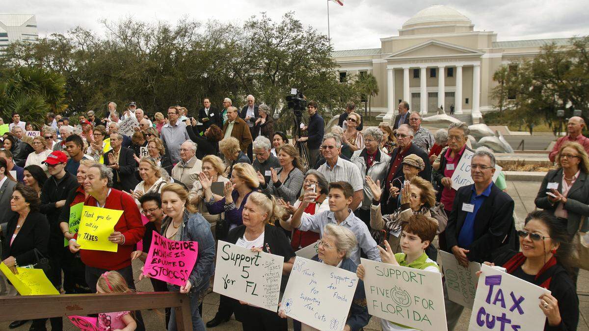 In front of the Florida Supreme Court, activists hold up signs during a rally March 3, 2014, in Tallahassee. ASSOCIATED PRESS FILE PHOTO