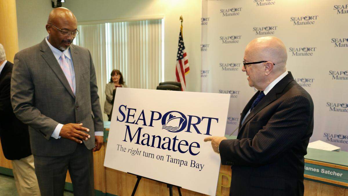 Reggie Bellamy, Manatee County Port Authority chairman, left, and Carlos Buqueras, executive director of SeaPort Manatee, stand in front of a Seaport Manatee logo on 2/17/2022.