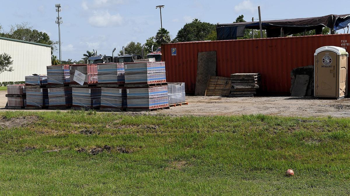A soccer ball rests in the grass near where a 7-year-old boy was killed when a forklift accidentally dropped empty pallets that were being removed from a truck in an industrial area of Palmetto.