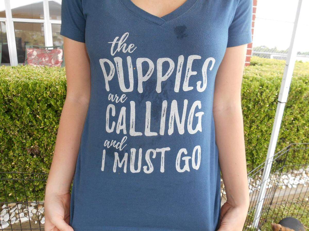 Flight and ground crew volunteers each get a shirt that reads "The puppies are calling and I must go."
