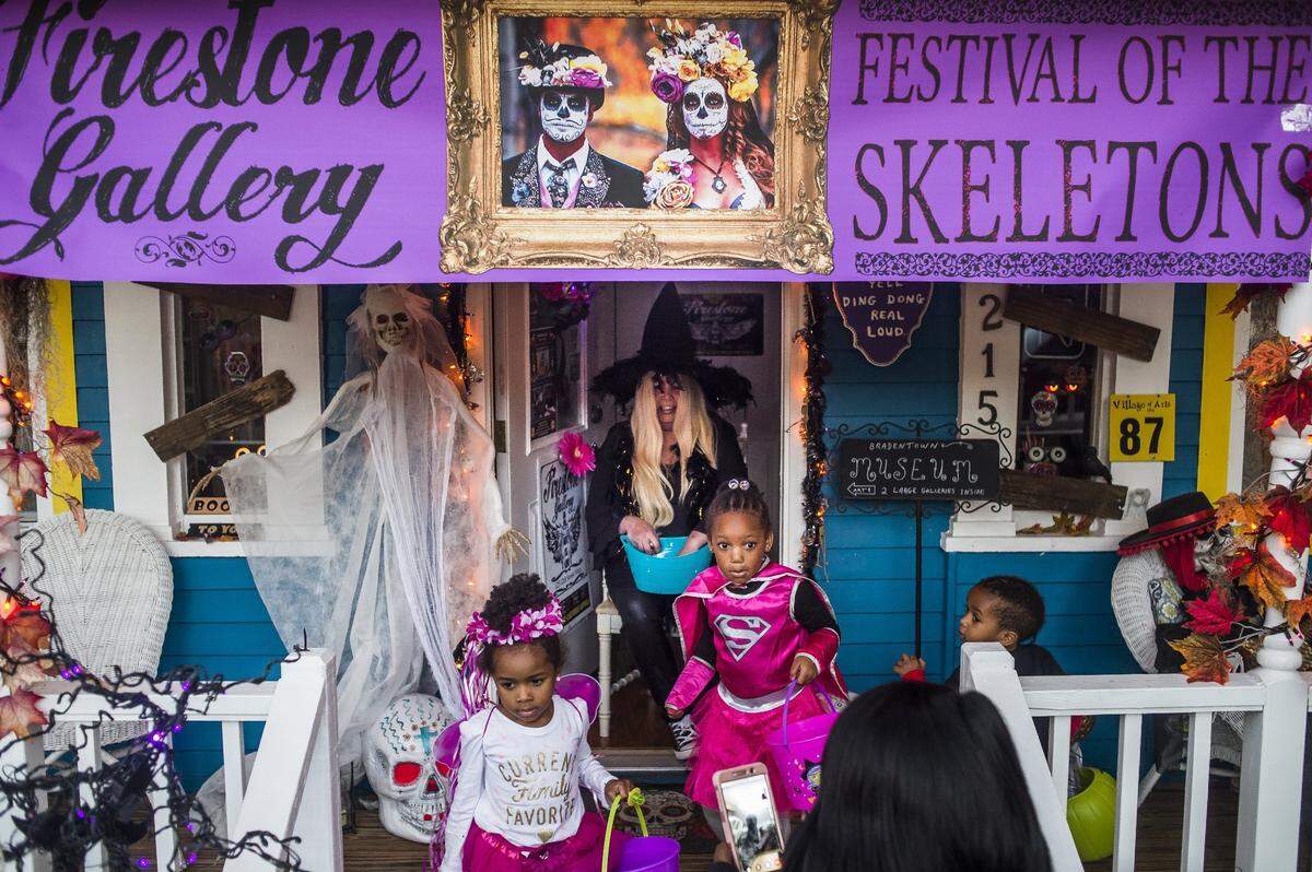 Residents pass out candy in heavily decorated spooky houses as costumed children take to the streets of the Village of the Arts on Hallowee in Bradenton.