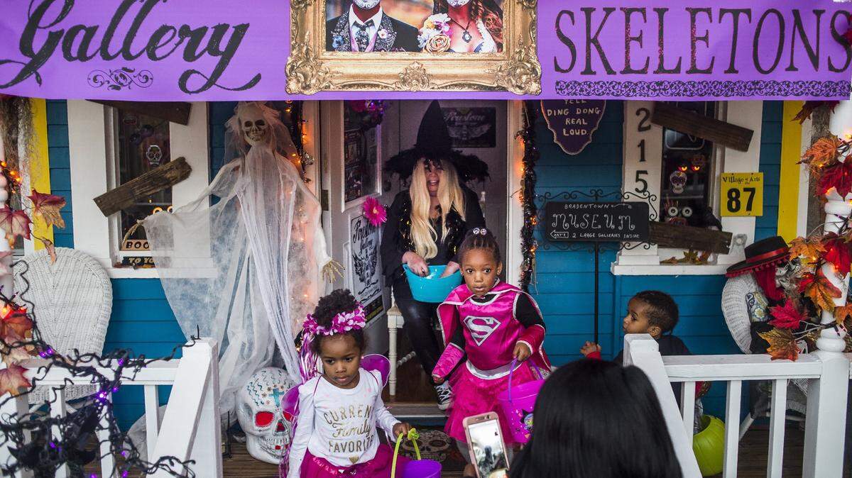 Residents pass out candy in heavily decorated spooky houses as costumed children take to the streets of the Village of the Arts on Hallowee in Bradenton.