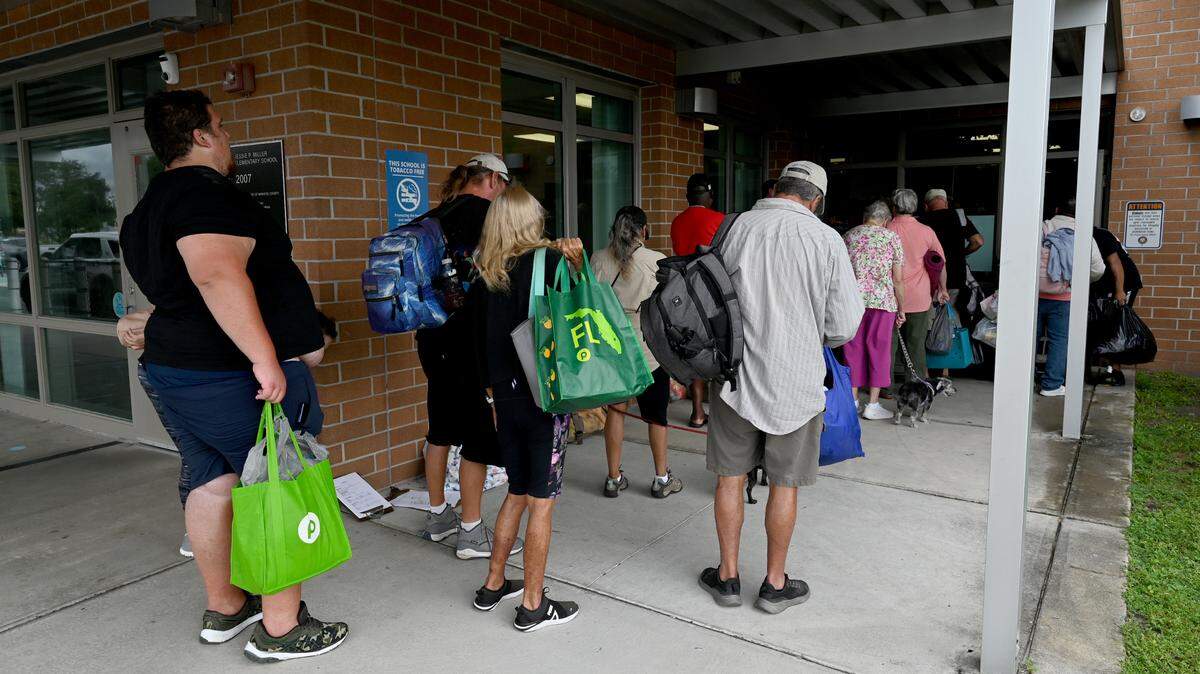 A line formed out the door of J.P. Miller Elementary School which opened as a shelter for evacuees as Hurricane Milton approaches Manatee County on Oct. 7, 2024. Manatee County Public Schools reopened Tuesday, Oct. 15, 2024.