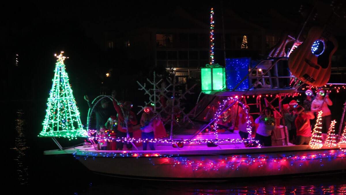A boat lit with more than 10,000 lights shows off for guests at the Bradenton Yacht Club during the Manatee River Holiday Boat Parade Saturday night.