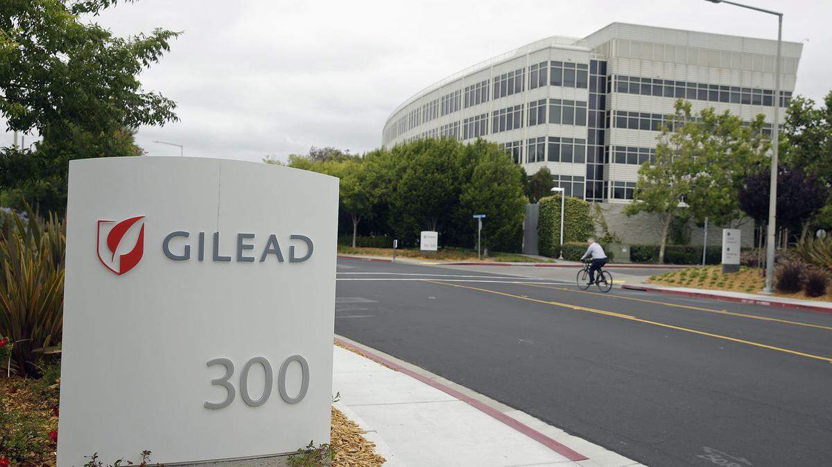 In this photo taken July 9, 2015, a man cycles near the headquarters of Gilead Sciences in Foster City, Calif. A bipartisan investigation by U.S. senators finds that the makers of a breakthrough drug for hepatitis C infection put profits before patients in pricing the $1,000-per-pill cure. The report released Tuesday by the Senate Finance Committee concludes that California-based Gilead Sciences was focused on maximizing revenue even as its own analysis showed a lower price would allow more patients to be treated for the liver-wasting disease. (AP Photo/Eric Risberg)