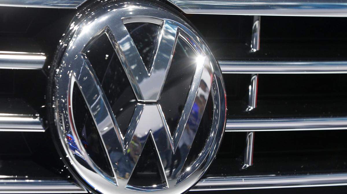 FILE - In this Sept. 22, 2015, file photo, the Volkswagen logo of a car is photographed during a car show in Frankfurt, Germany. A dealer familiar with Volkswagen's plans says the automaker intends to offer $1,000 in gift cards and vouchers to owners of smaller diesel cars as a gesture of goodwill to owners with 2-liter four-cylinder diesel engines that have been implicated in an emissions cheating scandal. (AP Photo/Michael Probst, File)