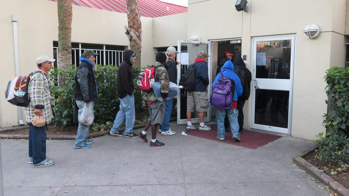 Men walk into the Salvation Army of Manatee County Wednesday evening to seek shelter. 
 AMARIS CASTILLO/Bradenton Herald