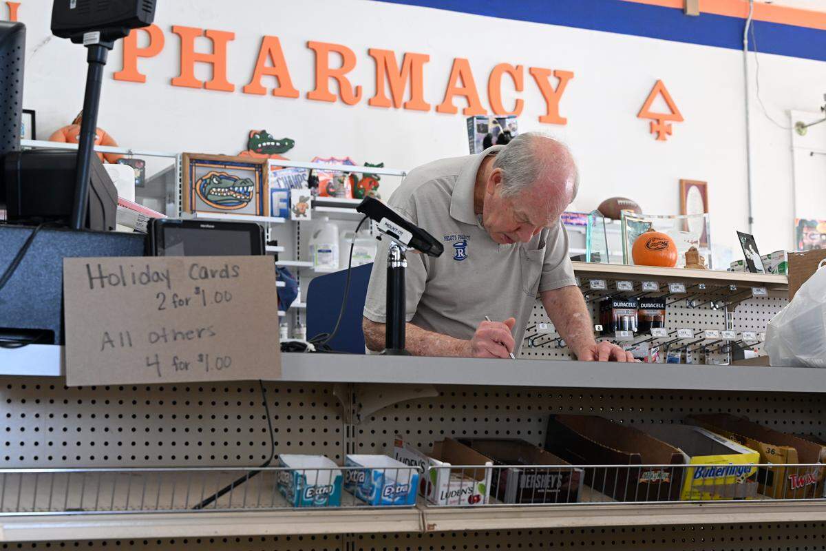 Robert Pelot works on paperwork on his last day in his family store. Pelot’s Rexall Pharmacy in downtown Bradenton closed its doors on Wednesday after over 130 years in business. Shown on March 4, 2026.