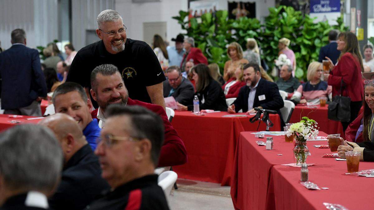 Sheriff Rick Wells laughs with friends at the luncheon for the Manatee County Fair’s distinguished citizens on Jan. 5, 2023.