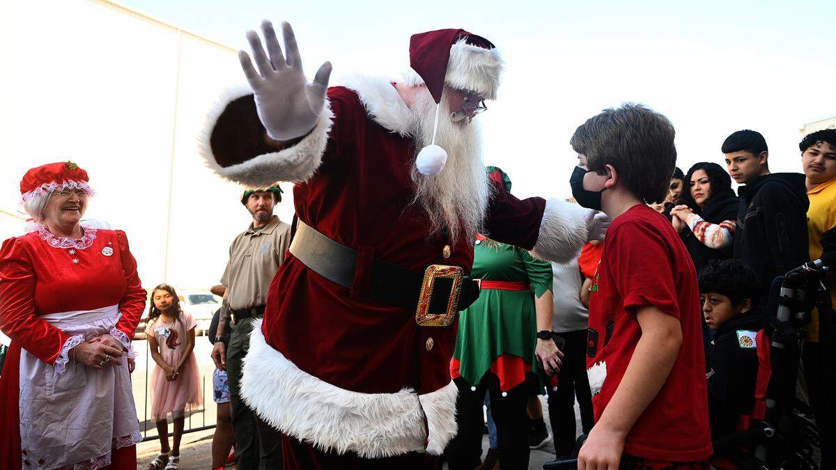 Santa Claus greets children after arriving via Monster truck at the 37th annual Flight to the North Pole program for children with disabilities and terminal illness and their families. The event was founded by Sidney Ettedgui of the Manatee County Sheriff’s Office and Eastern Airline Flight attendants with the help of the Sarasota/Bradenton Airport Fire Dept. and Feld Entertainment.