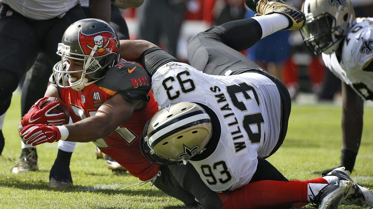 New Orleans Saints defensive tackle Kevin Williams (93) takes down Tampa Bay Buccaneers running back Charles Sims (34) during the third quarter of an NFL football game Sunday, Dec. 13, 2015, in Tampa, Fla. (AP Photo/Brian Blanco)