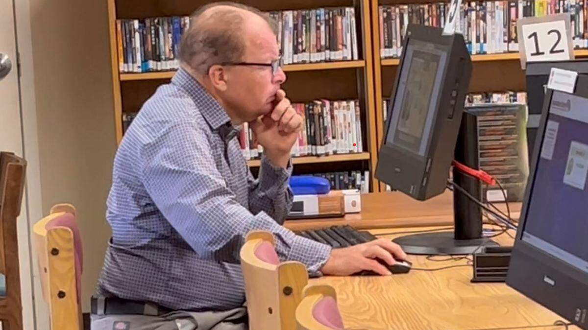 A man works at a computer inside the DeSoto County Library. The library’s access to the internet is a lifeline to many county residents.