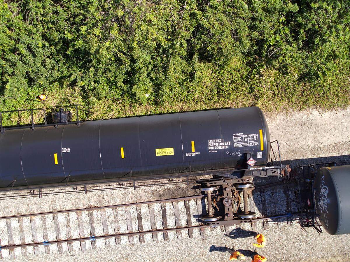 Workers inspect a Seminole Gulf Railways train that derailed in Bradenton Feb. 28, 2023.