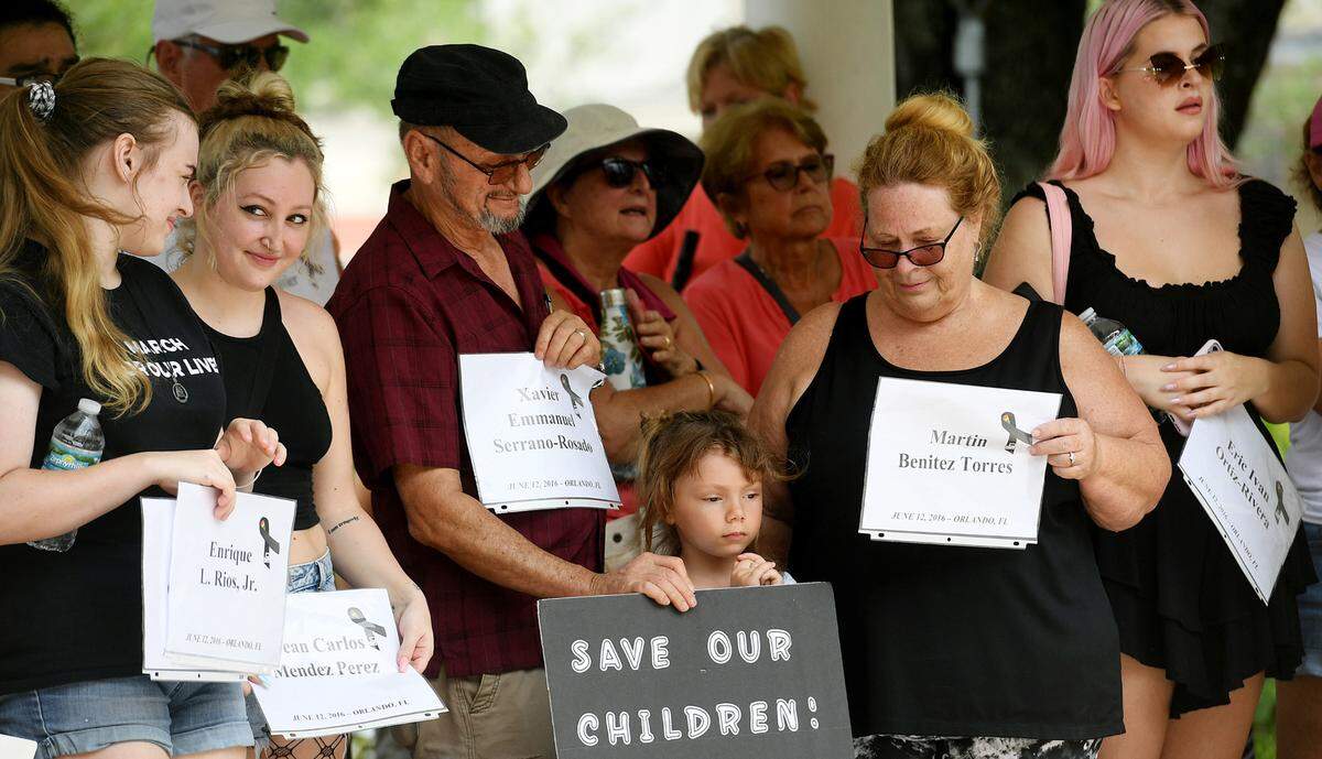 Marchers surround six year-old Persephone Dromeshauser during March For Our Futures, an anti-gun and violence march and rally organized by Women’s Voices of Southwest Florida, marches from the Riverwalk splash park to Bradenton’s Historic Courthouse.
