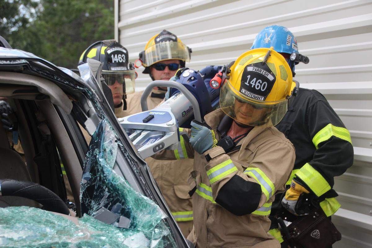 Captain Tim Gajan of the Parrish Fire District pops a door open on a Ford Explorer using a new Hurst Jaws of Life spreader.
