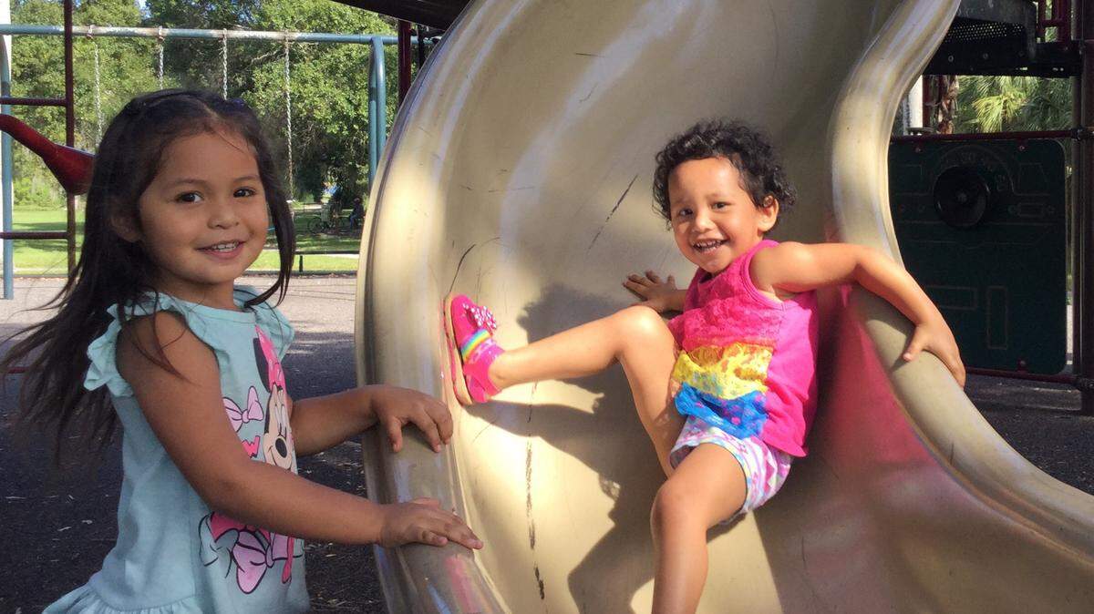 Yalina Perez-Ambriz, 3, and her younger sister Yaslin, 2, play in Glazier-Gates Park Friday as they do every weekday with mom while dad betters his family's future by taking nearby GED classes during the day. The park will be removed and relocated to make way for a 521-unit rental complex as part of a land swap deal with the city of Bradenton. Like many others, losing century old oak trees and a well established family park is something the family is very disappointed about. MARK YOUNG/Bradenton Herald