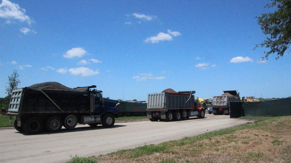 Dump trucks line up to deliver site preparation material to The Landings at Heritage Harbour, a 264,987-square-foot retail development rumored to be anchored by Costco.