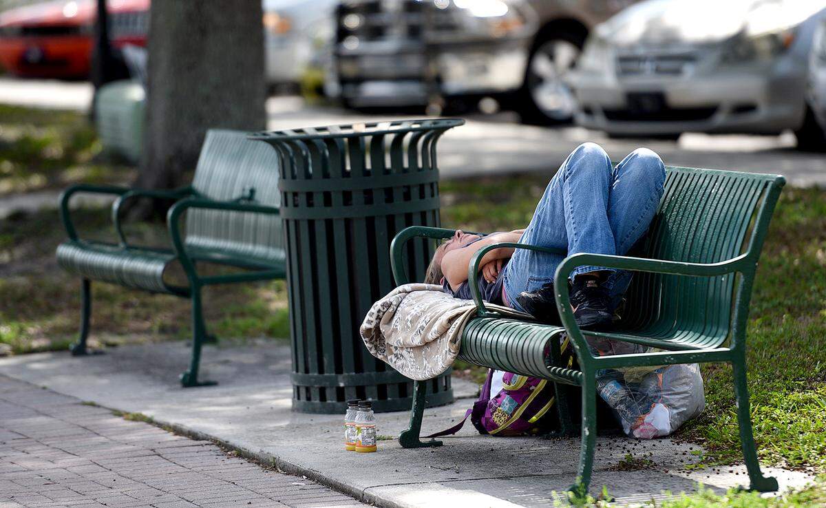 A woman rests on a bench in downtown Bradenton, where most businesses are closed. Florida Senate President Bill Galvano wants Manatee County homeless tested for COVID-19, the disease caused by the coronavirus.