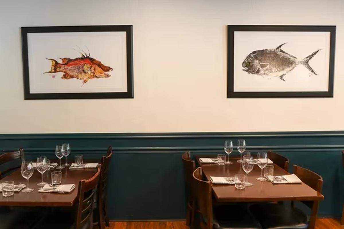 “Fish rub” rice paper prints from artist Linda Heath hang throughout the dining room at Meliora.