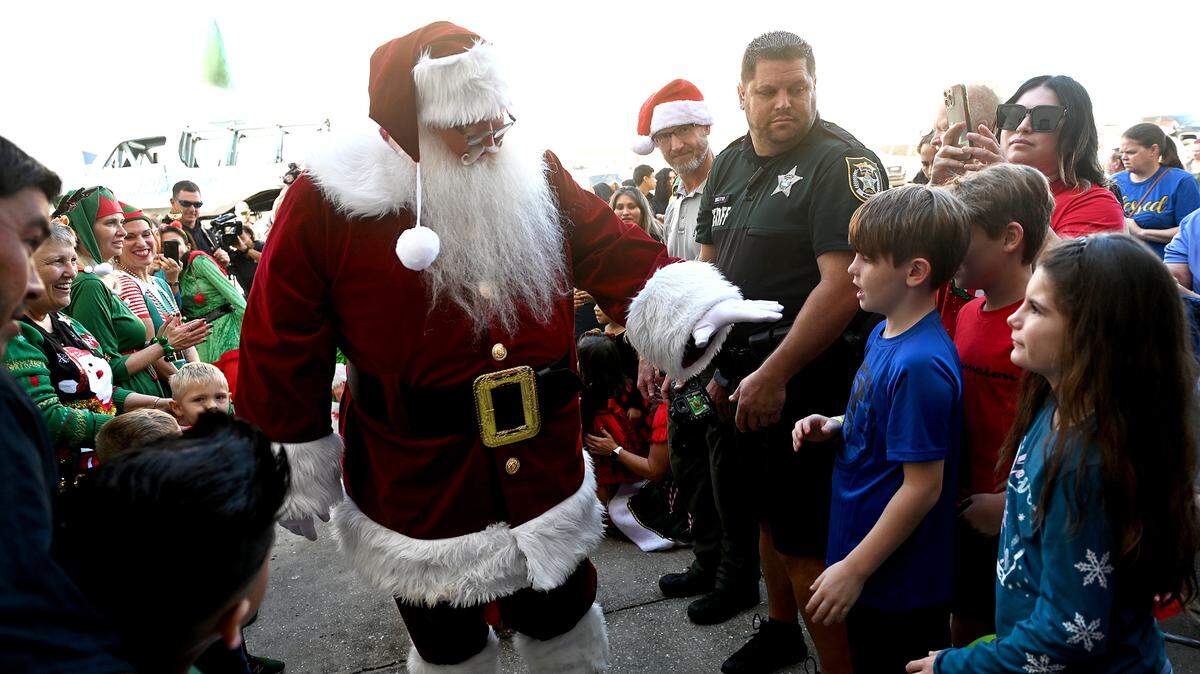 Santa Claus greets children after arriving via Monster truck at the 37th annual Flight to the North Pole program for children with disabilities and terminal illness and their families. The event was founded by Sidney Ettedgui of the Manatee County Sheriff’s Office and Eastern Airline Flight attendants with the help of the Sarasota/Bradenton Airport Fire Dept. and Feld Entertainment.