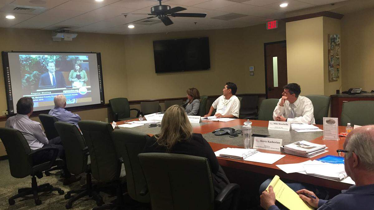 Manatee County Citizens Financial Structure Advisory Board members watch a video of the county's financial adviser speaking. The advisory board said Thursday the county has a funding problem.CLAIRE ARONSON/Bradenton Herald