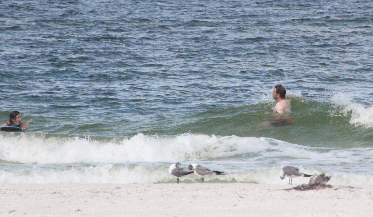 Most beach goers stayed out of the water on Anna Maria Island because of red ride, but not all.