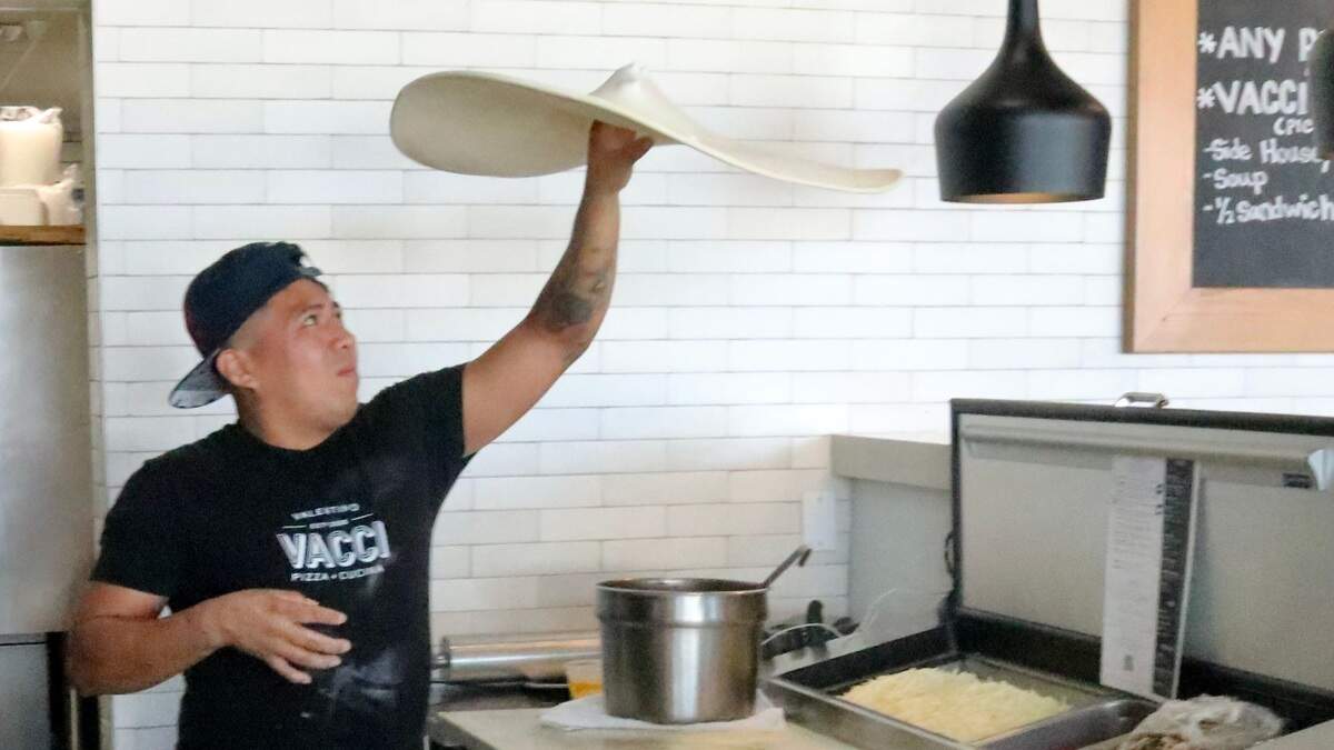 Leo Flores tosses a pizza at Vacci Pizza & Cucina, 4406 53rd Ave. E., Bradenton. The restaurant offers pizza by the slice, lunch specials and entrees six days a week.