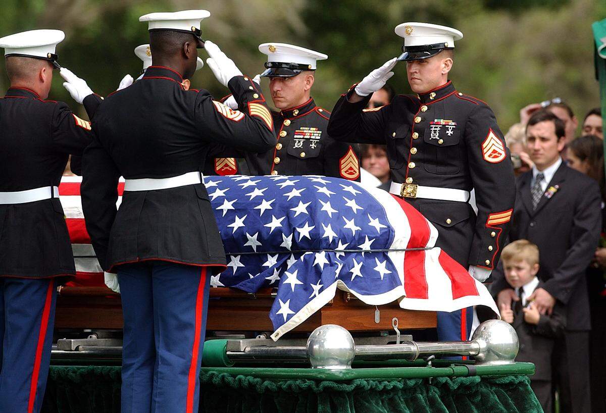 Marines from the 4th Assault Amphibian Battalion salute over Pfc. Christopher Cobb's casket during his burial service at Manasota Memorial Park on April 14, 2004.