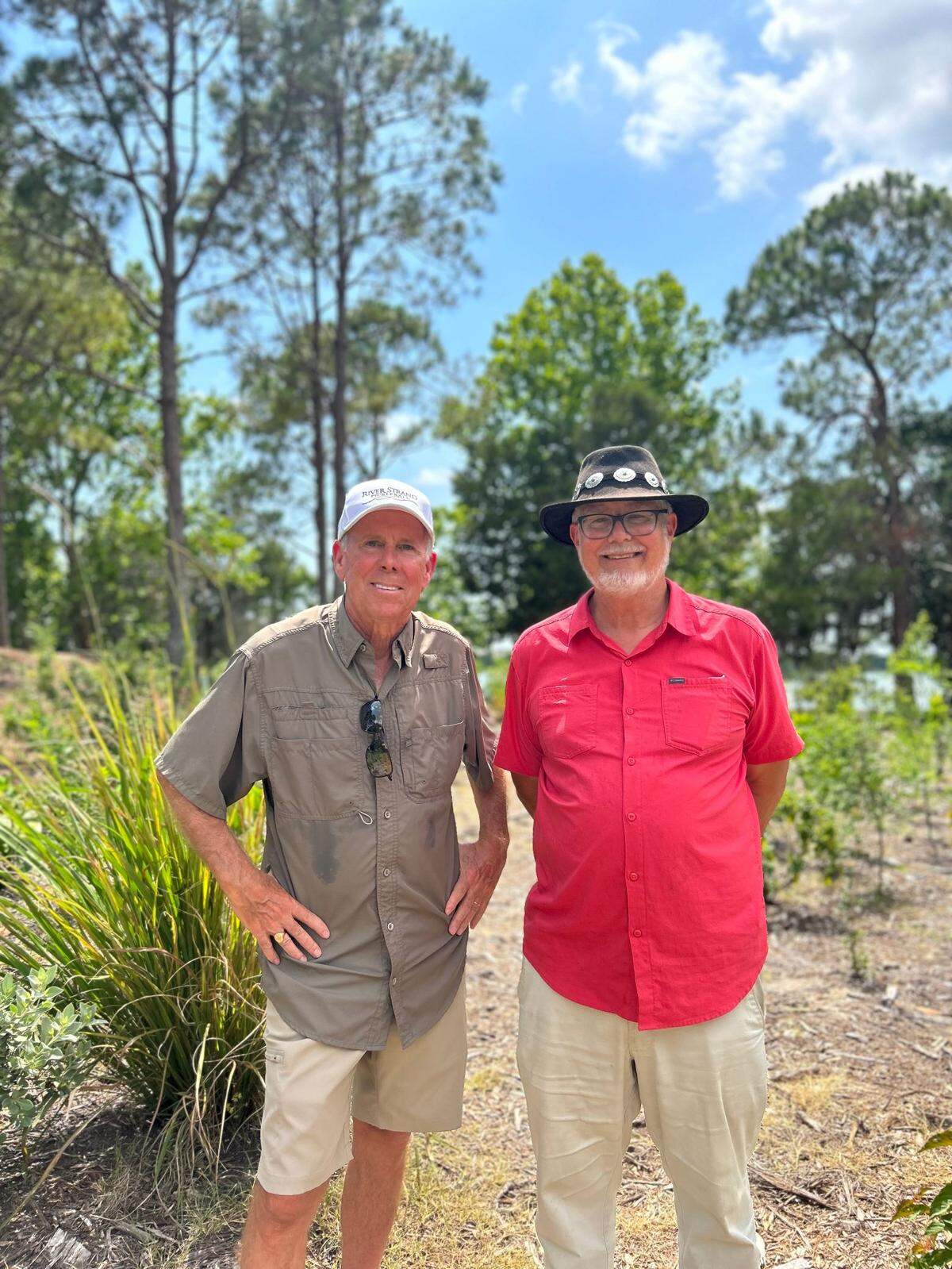 Charles Reith, right, the project manager for SURF, and Don Smith, a board member for the Heritage Harbor Master Association, stand in the Heritage Harbor Playground Microforest.