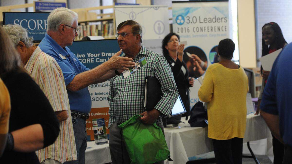 People attend a small business expo Monday at the Manatee County Central Library. 
 GRANT JEFFERIES/Bradenton Herald