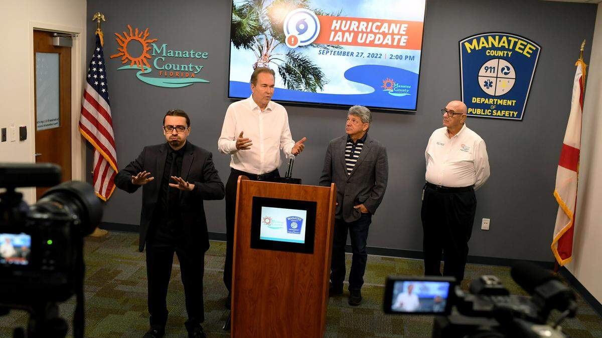 Manatee County Administrator Scott Hopes gives an update on Hurricane Ian with U.S. Rep. Vern Buchanan and Dep. Dir. of Public Safety Steve Litschauer with interpreter David Maruca, left at the Emergency Operations Center on Sept. 27, 2022.