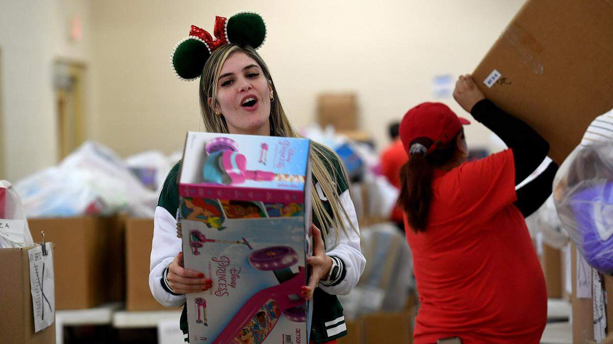 Volunteer Maria Diaz works with dozens of volunteers to gather toys that were collected for 786 families on the Salvation Army’s Angel Tree Distribution Day. Families registered in September to receive presents for their children along with a turkey or ham. The distribution was drive-through style, with volunteers working together to make the event run smoothly.